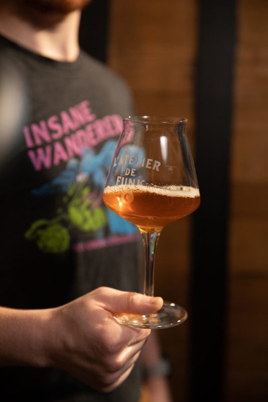 Employee holding sour beer
